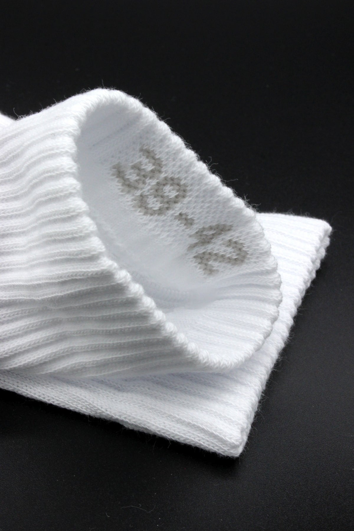 White Sk8erboy socks with "Sniff Me" on the sole and large logo in close-up