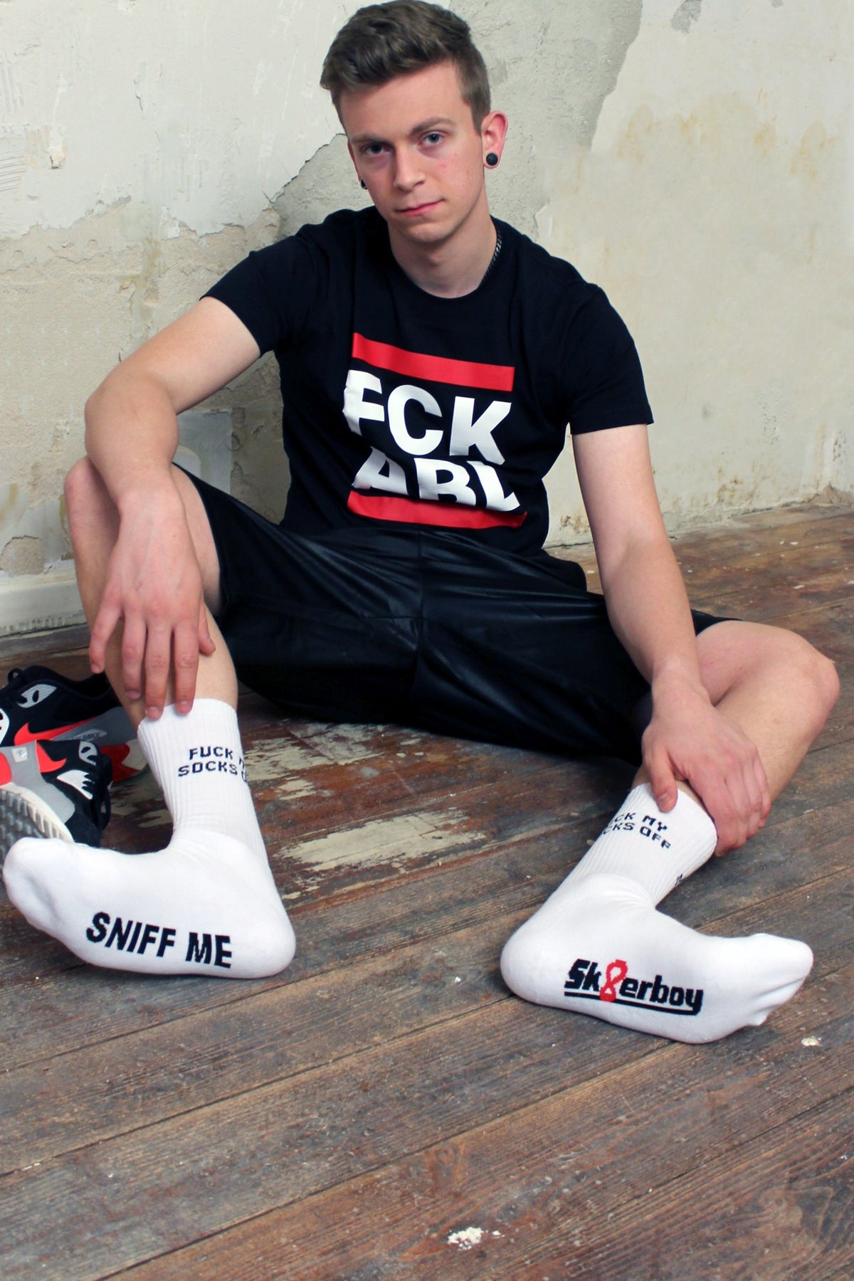 sk8erboy Sniff Me socks with a bold black print on the white socks, wearing a fck abl T-shirt from sk8erboy